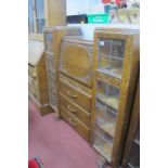 A 1920's Oak Side by Side Cabinet, having lead glazed cupboard doors, fall centre bureau over