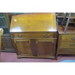 A Mahogany Bureau, with fall front, fitted interior over single drawer and cupboard doors, 94cm