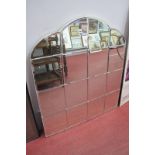 An Art Deco Style Wall Mirror, having wavy top and sixteen bevelled panels, 89cm high 81.5cm wide.