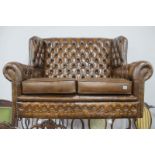 Leather Brown Button Back Two Seater Settee, with studded decoration.