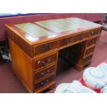 A Yew Wood Pedestal Desk, with green scriver insets to flat top, three drawers, over flight of three