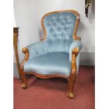 A XIX Century Mahogany Arm Chair, with a hoop back on cabriole legs, upholsted in a blue damask.