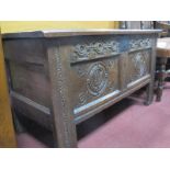 A XVII Century Jointed Oak Blanket Box, with a three panelled top, carved frieze, carved panels on