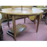 A Dalescraft Teak Extending Dining Table, with two spare leaves under top, on tubular legs,