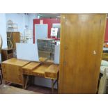 A 1950's Teak Three Piece Bedroom Suite, comprising a single wardrobe, chest of three drawers on