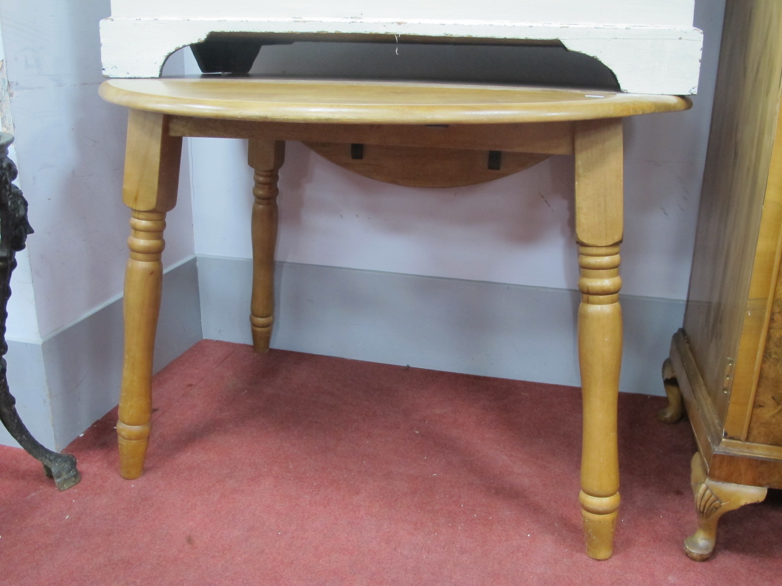 A Kitchen Table, with drop leaves, on turned legs.