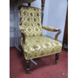 A XIX Century Rosewood Armchair, with shaped arms, on turned legs, upholstered in a floral damask.