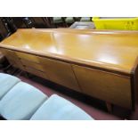 Teak Sideboard, circa 1970's, with curved low back and top at front, three drawers flanked by fall