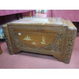 A Mid XX Century Oriental Camphor Chest, with extensive carving and inlaid with brass pagodas,