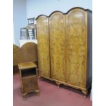 A 1920's Walnut Three Door Wardrobe, with a triple dome pediment, three doors on small cabriole