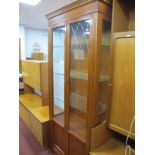 A Yew Wood Display Cabinet, with glass doors, sides, three internal shelves, on bracket feet.