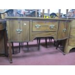 An Early XX Century Mahogany Sideboard, with a central drawer, flanking cupboard doors, on