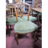 A Set of Eight Walnut Dining Chairs, with shaped top rail and centre panel, upholstered seats, on