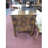 An Oak Side Cupboard, with twin arch panel doors over single drawer on block supports, 71cm wide.