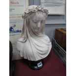 An Italian Bust of The Veiled Lady, on black circular base, 34cm high.