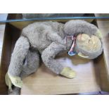 A Merrythought Monkey, in the form of a night gown case, sleeping eyes, 28m high.