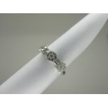 A Dainty 18ct White Gold Diamond Set Ring, of triple cluster design, claw set throughout with