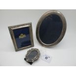 A Hallmarked Silver Mounted Oval Photograph Frame, FH, Sheffield 1986, of plain oval form on blue