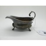 A Hallmarked Silver Sauce Boat, EBSs, London 1938, with leaf capped flying scroll handle, raised