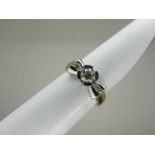 A Modern 18ct Yellow and White Gold Three Stone Diamond Ring, of stylised design, set to the