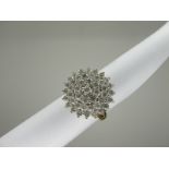 An 18ct Gold Diamond Cluster Ring, of circular design, claw set throughout with uniform brilliant