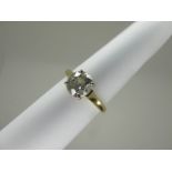 An 18ct Gold Large Single Stone Diamond Ring, the (7mm) old brilliant cut stone four claw set,