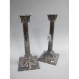 A Pair of Classical Style Plated Candlesticks, of classical column form with garland swag detail, on