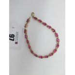 A Modern 9ct Gold Cruzeiro Rubellite Set Line Bracelet, oval four claw set throughout, 19cm long (