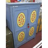 A Pale Blue Painted Wardrobe, with painted floral panels, 111 cms.
