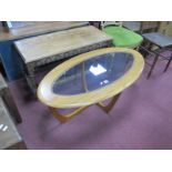 An Oval Laminate Coffee Table, in the Astra style having glass inset top, 107cm wide, an oak