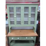 A Green Painted Kitchen Dresser, the rack with glazed doors, base with two drawers, on square