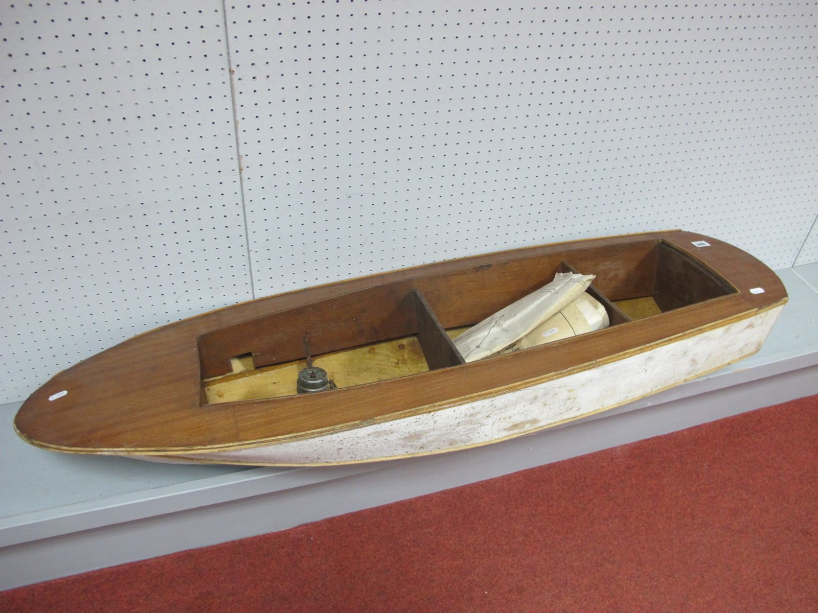 A Fairey Huntsman 31 Partially Built Radio Controlled Boat Hull. with motor present, and large paper