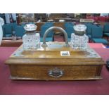 An Oak Desk Stand, with nickel mounts and carry handle, twin glass inkwells top top, 31cm wide.