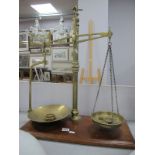 Brass Balance Scales, circa early XX Century with six weights, on mahogany base, 50.5cm wide.