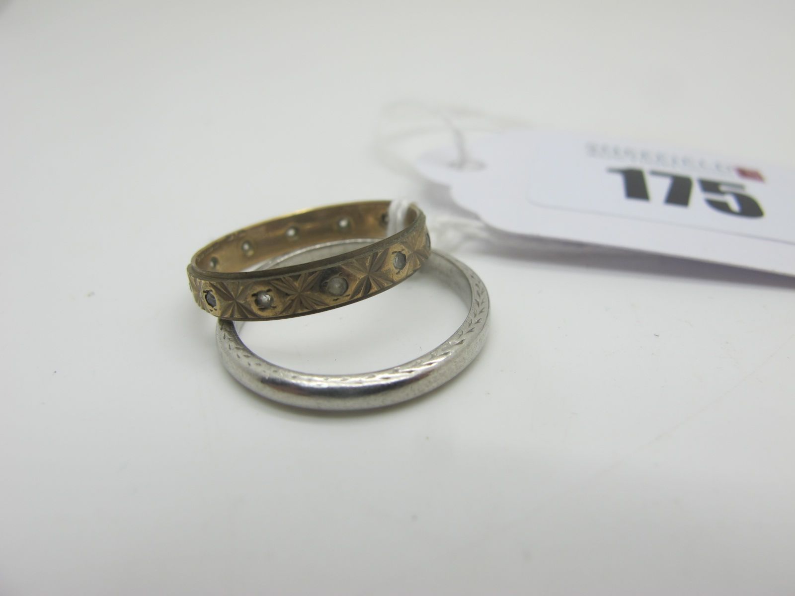 A Wedding Band, of part textured finish, stamped "H S Plat" (approximate finger size N) (3.