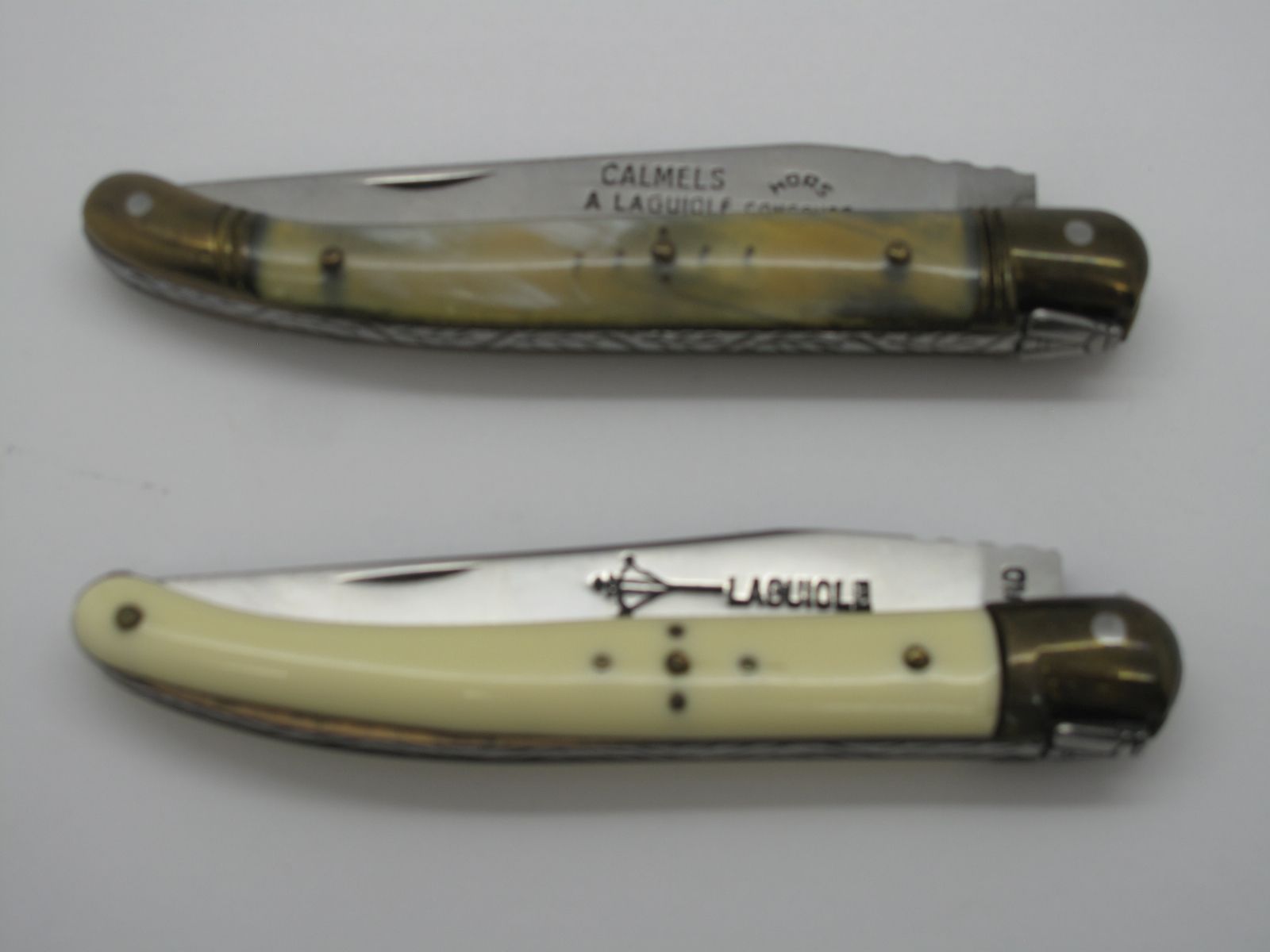 Two Pocket Knives by Laguiole; One with blade marked "Camels" in polished horn, bolsters to each
