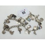 A Curb Link Charm Bracelet, suspending assorted novelty charm pendants; together with another