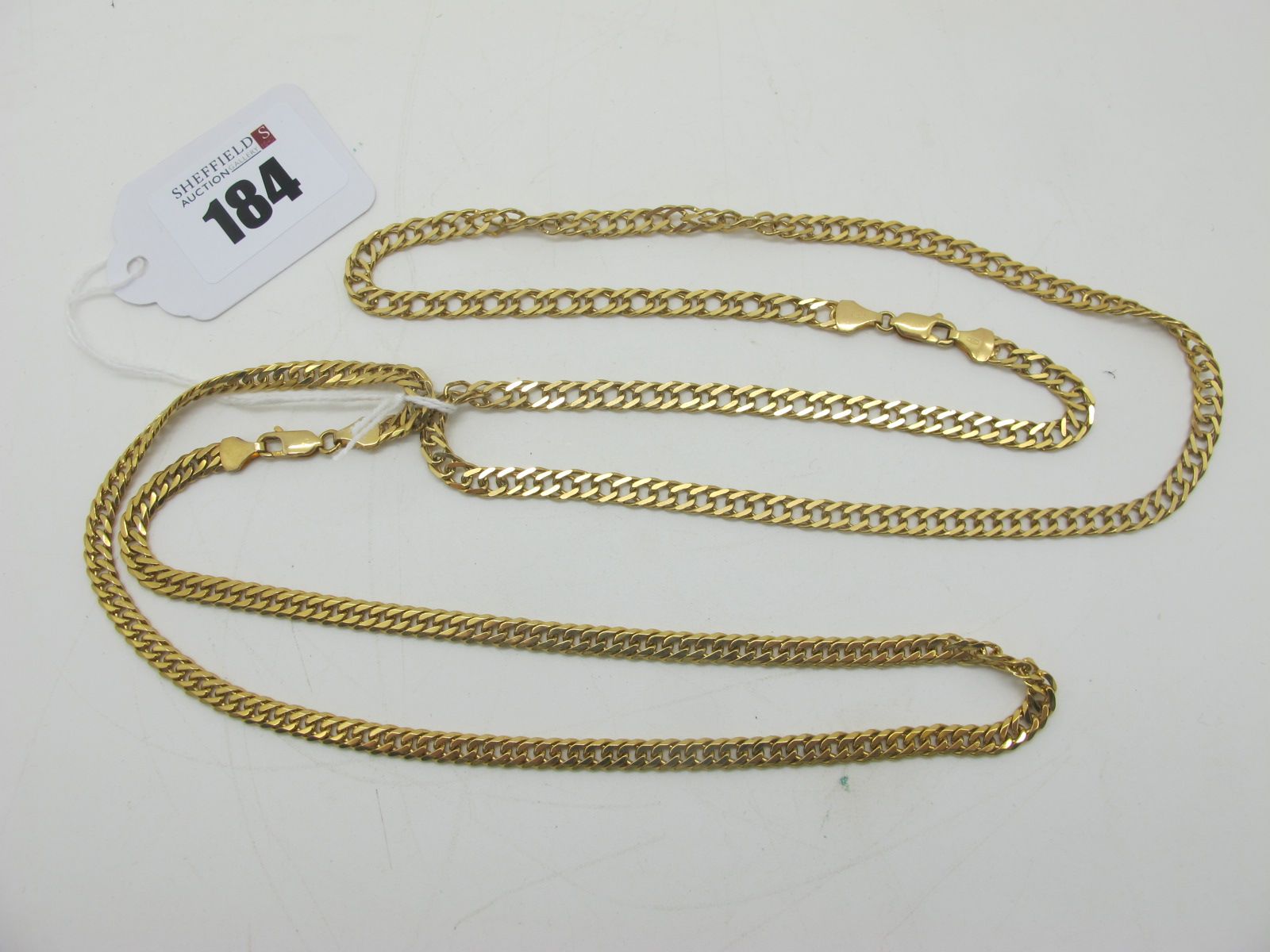 A 9ct Golf Curb Link Chain, 54cm long; together with another 9ct gold curb link chain, 45cm long.