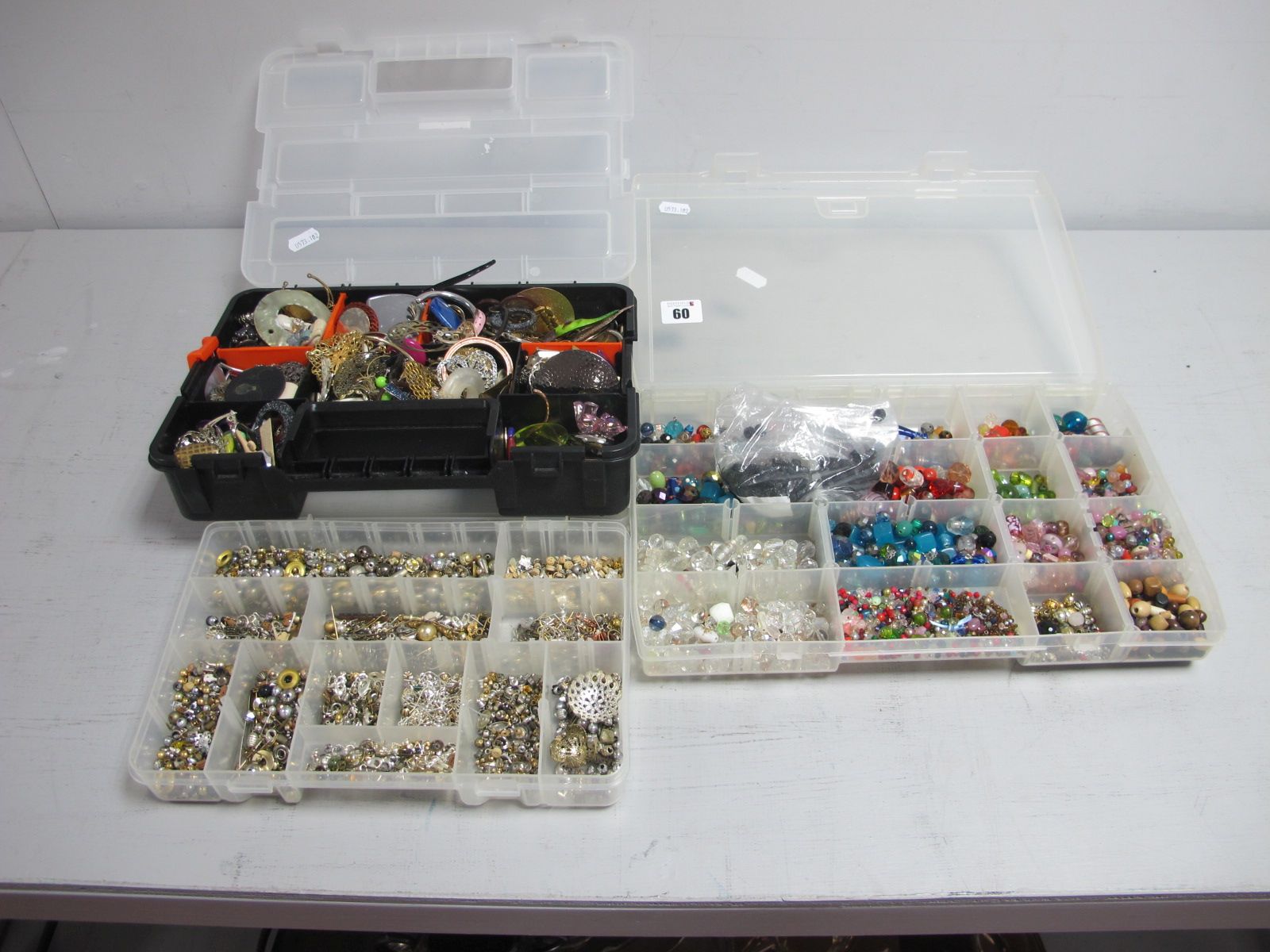 A Quantity of Assorted Beads, findings, etc for craft, etc, contained in three sectioned boxes.