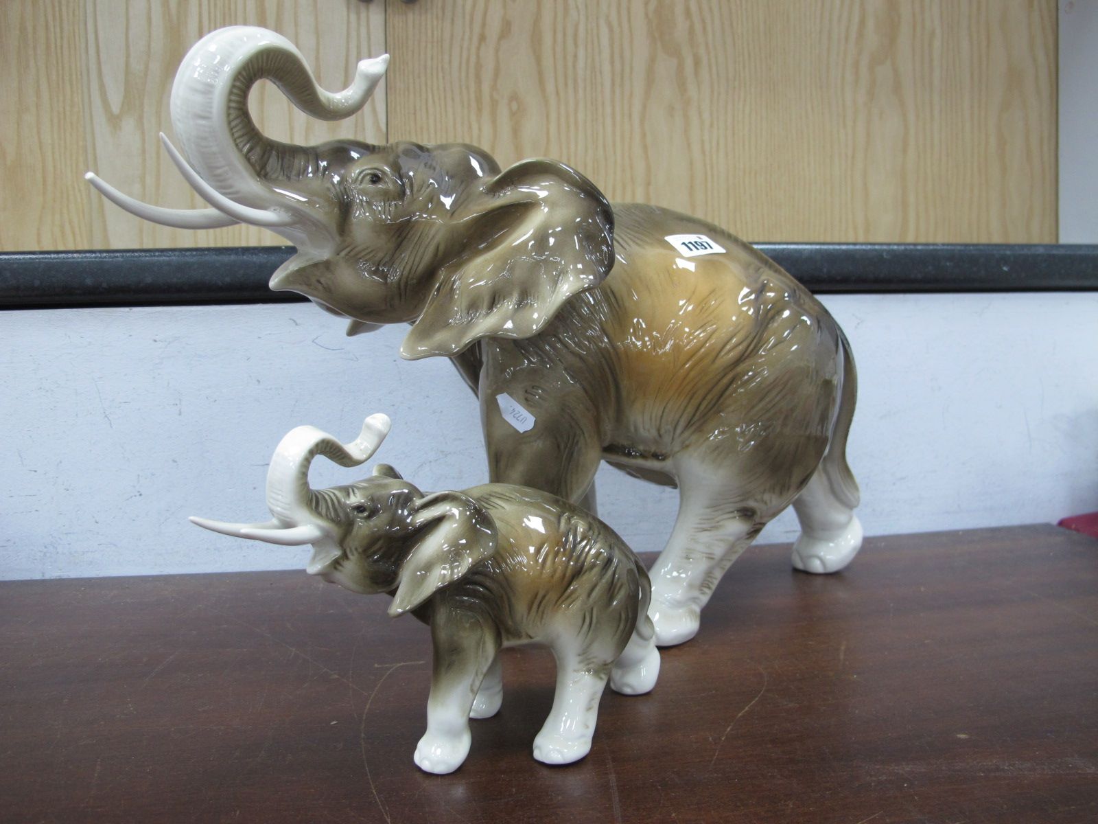 Royal Dux Elephant, (one tusk damaged) 32cm, another smaller. (2)
