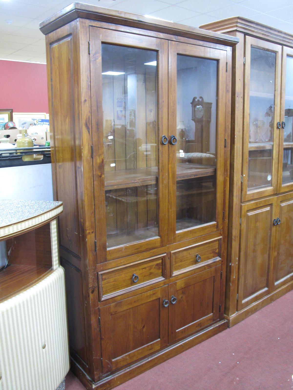 A Pine Effect Display Cabinet/Bookcase, with glazed doors, two internal shelves, two small drawers