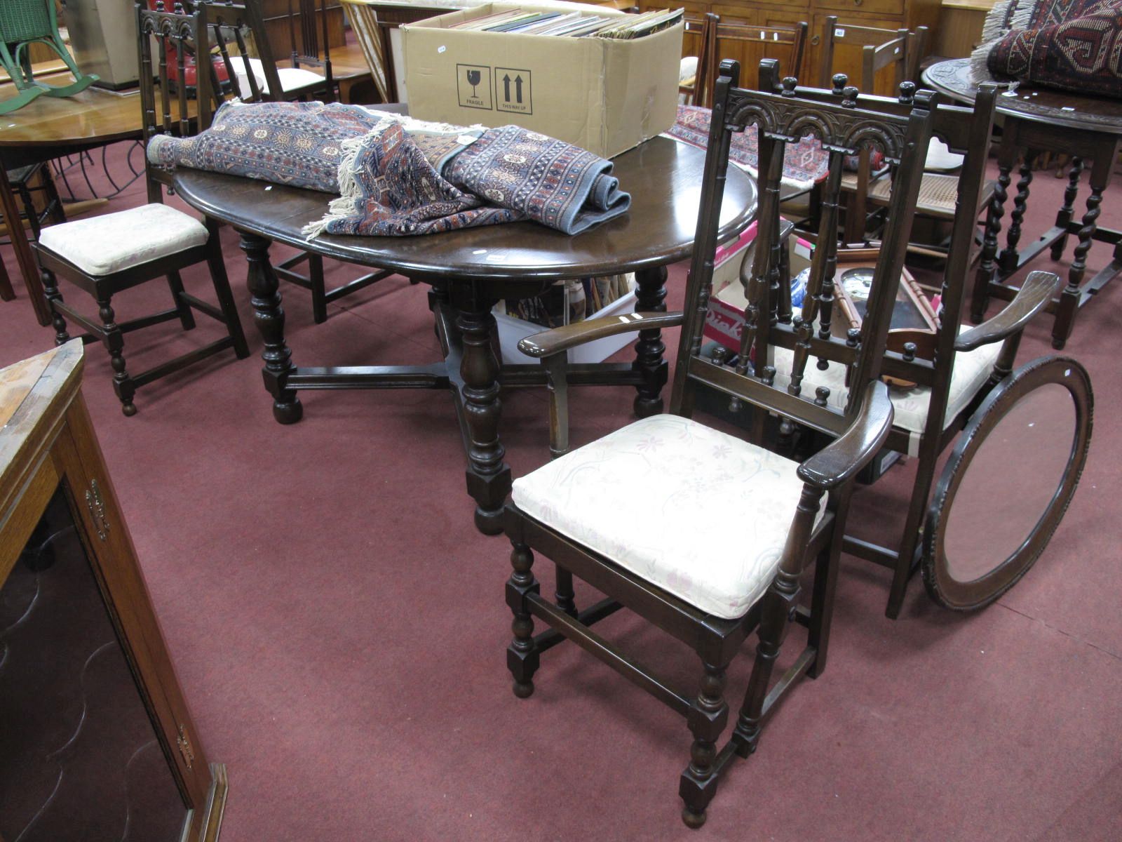 Ercol Dark Wood Oval Extending Dining Table, having fold out leaf to oval top, on turned and block