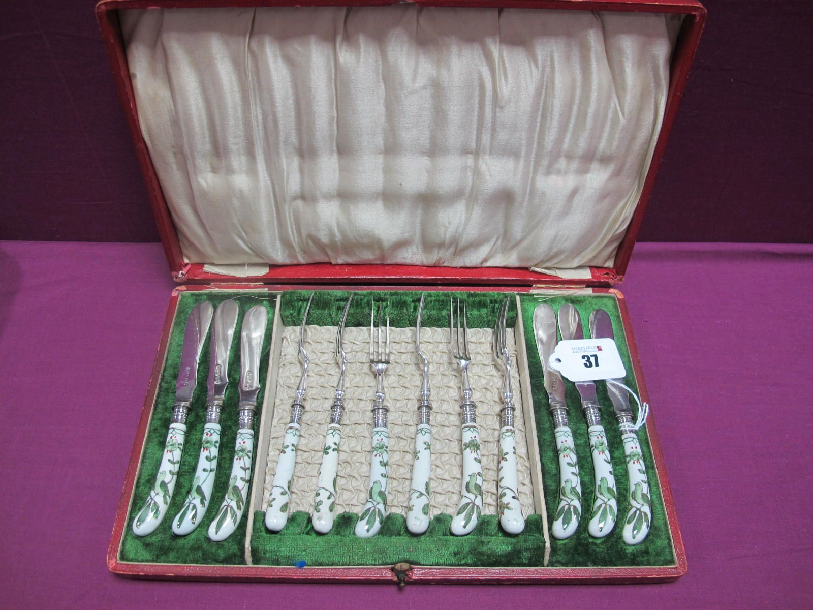 A Decorative Set of Six Ceramic Handled Knives and Forks, highlighted in green depicting birds (