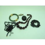 A Cherry Amber Coloured Single Strand Graduated Bead Necklace, together with a small collection of