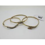 A 9ct Gold Serpent Bangle, with inset highlights to head; Together with Two Hinged Bangles, each