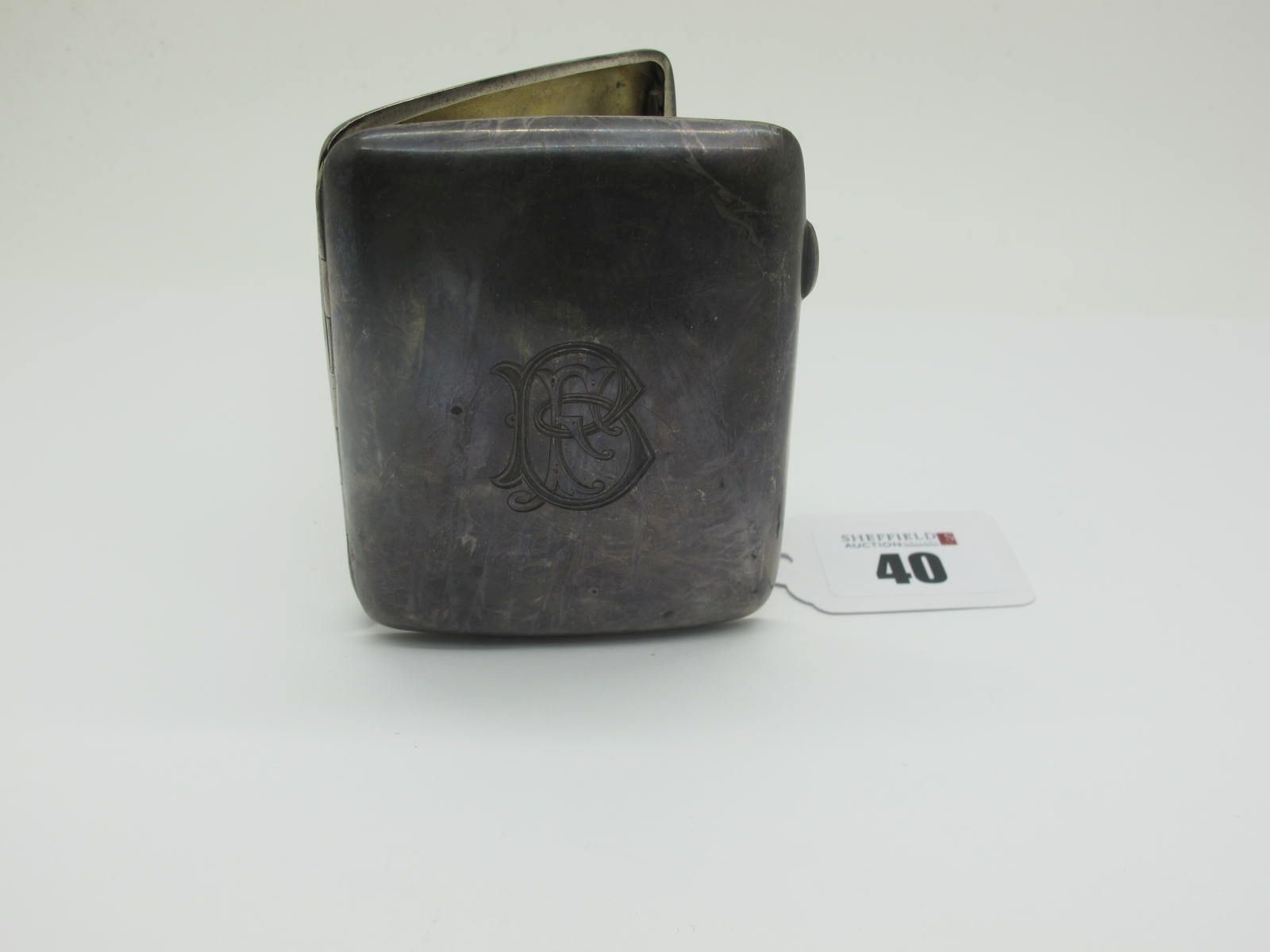 A Hallmarked Silver Cigarette Case, monogrammed (dents).
