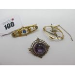 An Edwardian Amethyst and Seed Pearl Set Brooch, circular claw set to the centre, within openwork