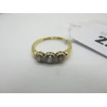 A Three Stone Diamond Ring, the old cut stones collet rubover set, stamped "18ct&PT" (finger size