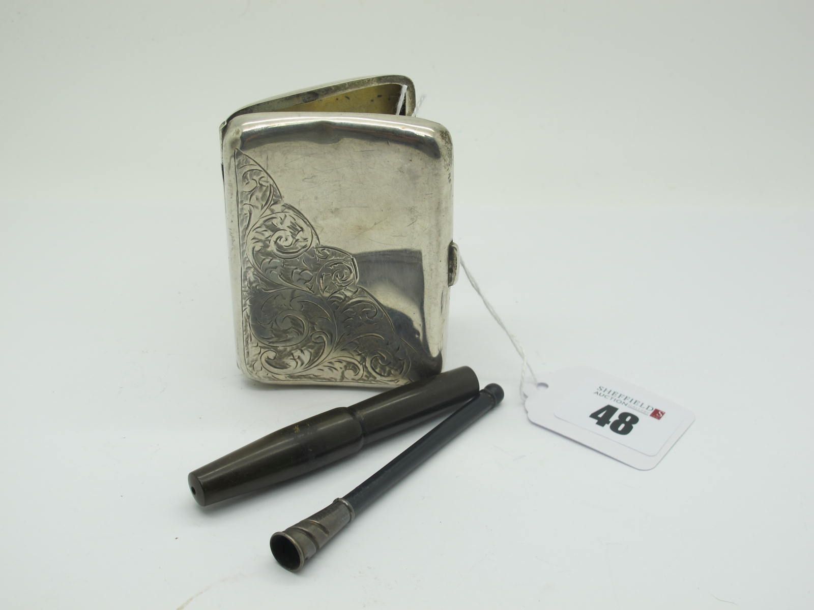 A Hallmarked Silver Cigarette Case, part leaf scroll engraved (dented); Together with A Cheroot