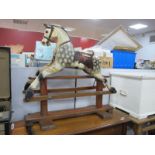 A XIX Century Rocking Horse, on a pine base, (in need of restoration), 83cms.